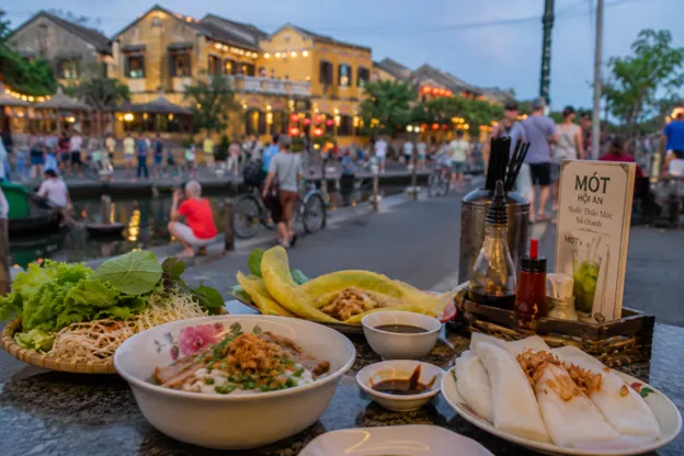 Colourful Hoi An lanterns hanging over a street food market at dusk