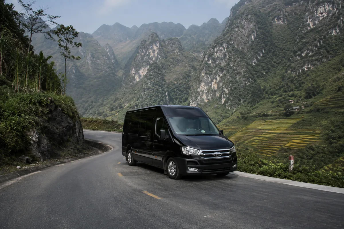 Private limousine van on a mountain highway between Hanoi and Ha Giang town.