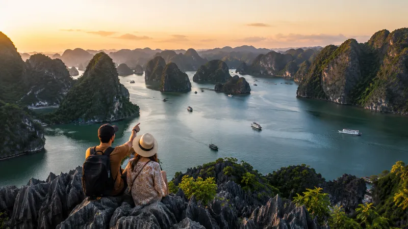 Couple watching the sunset over Ha Long Bay, Vietnam