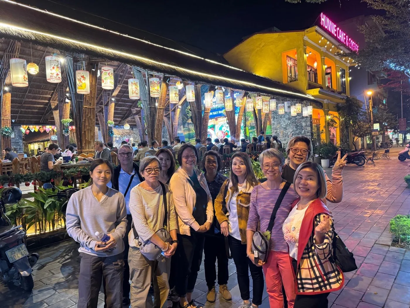 A group at a lantern-lit night street