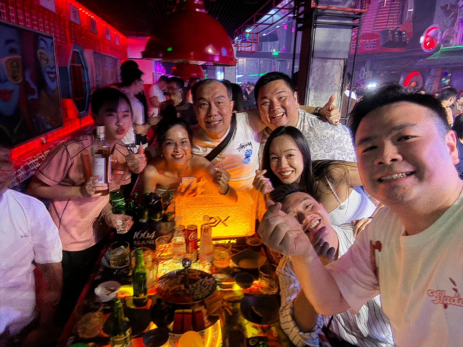 Group selfie at bar