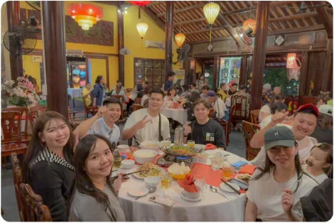 A family sharing a hotpot dinner in Hoi An