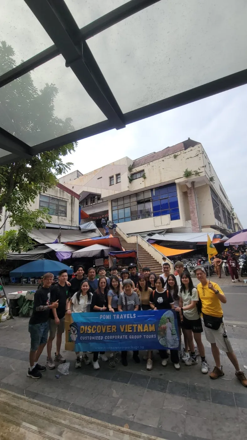 A POMI Travels group arriving in Vietnam with their Discover Vietnam banner