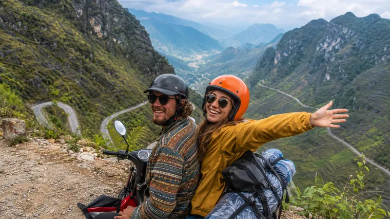 Couple on easy rider motorbike with winding mountain road behind them