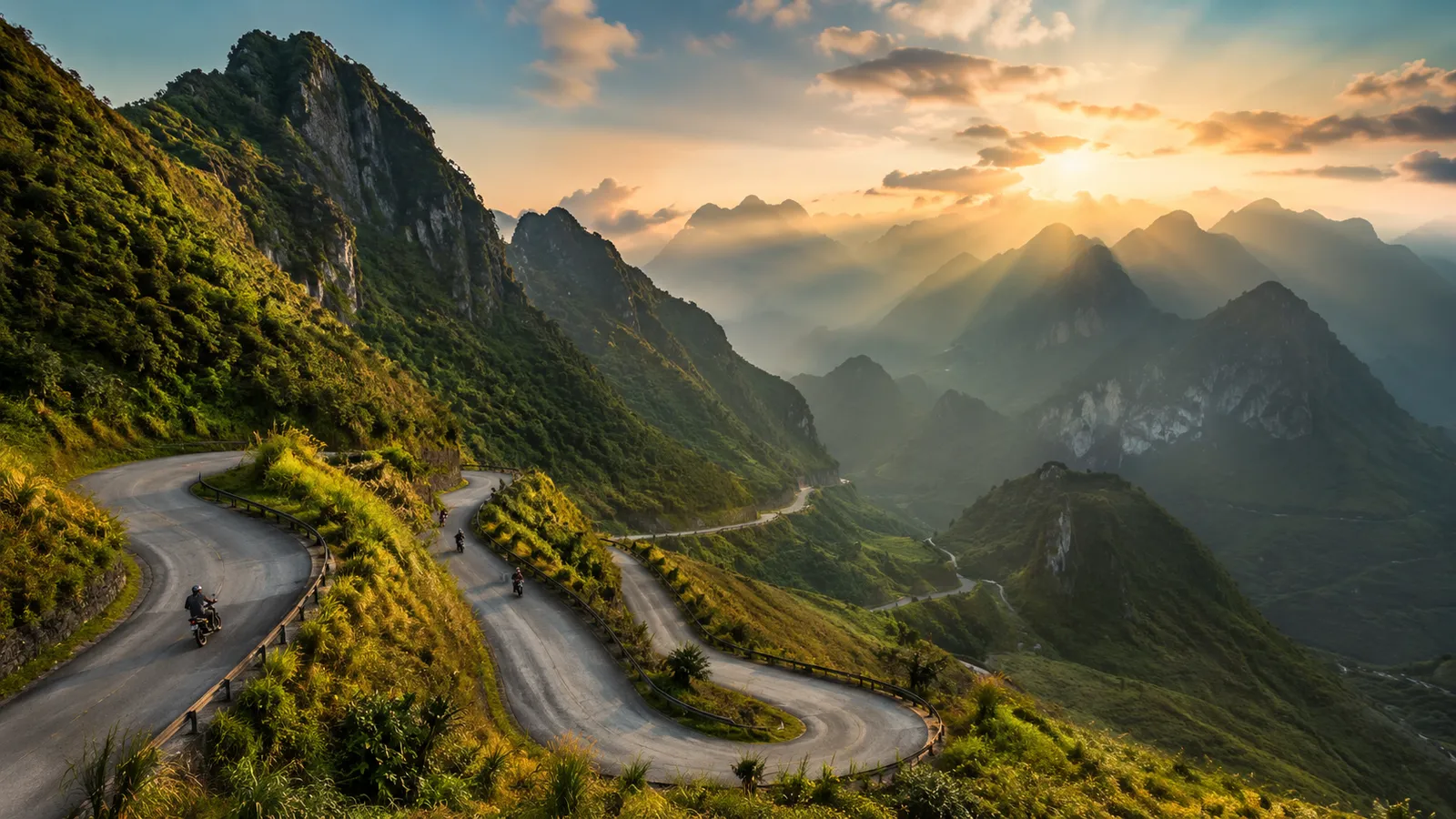 Motorbikes on a switchback mountain pass at sunset on the Ha Giang Loop in northern Vietnam