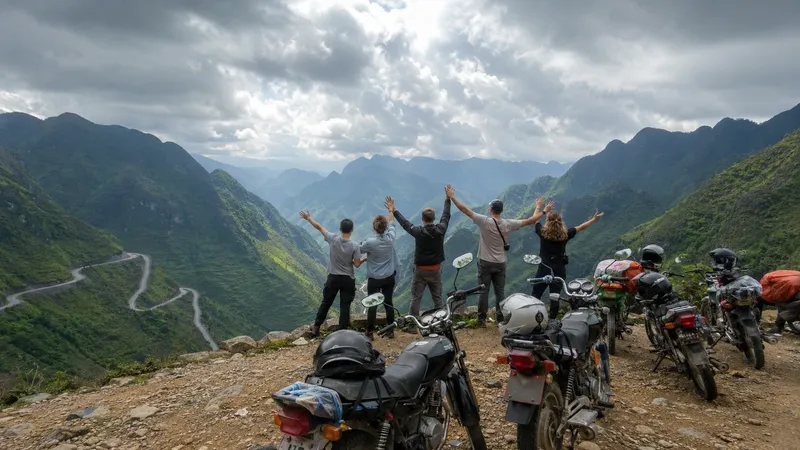 Group of travellers with arms raised at a Ha Giang Loop mountain viewpoint