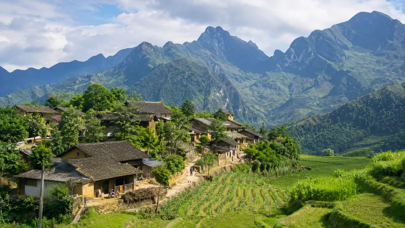 H'Mong villagers and traditional houses in a Ha Giang highland village