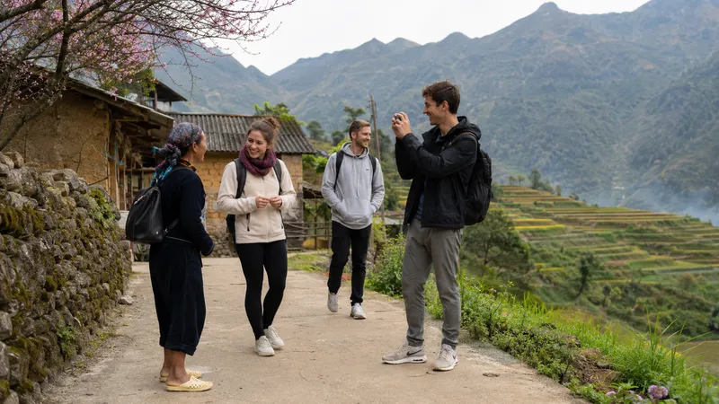 Travellers chatting with a local H'Mong woman in a highland village
