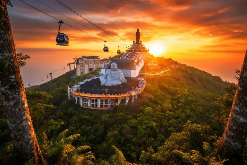 White Buddha statue at the summit of Ba Den Mountain in Tay Ninh at sunset with cable cars in the foreground