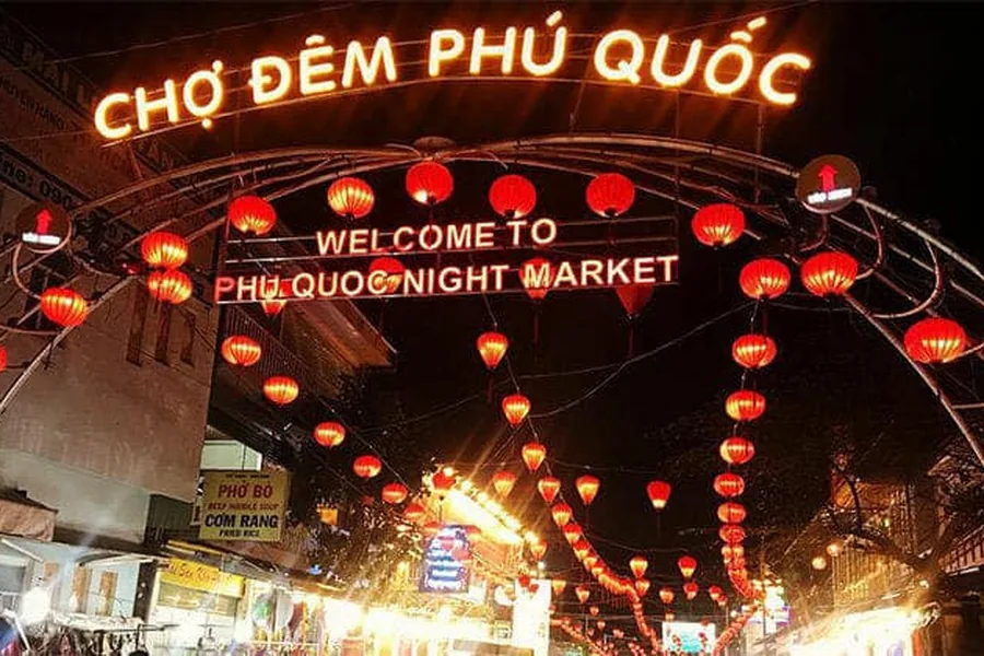 Phu Quoc Night Market entrance with a big wheel lit up at night