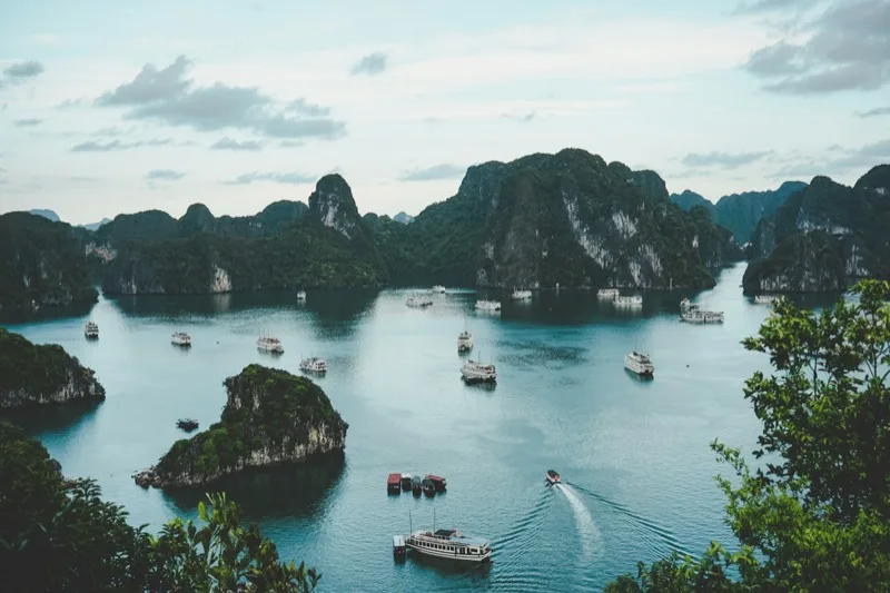 Limestone karst mountains rising from emerald waters in Ninh Binh Vietnam
