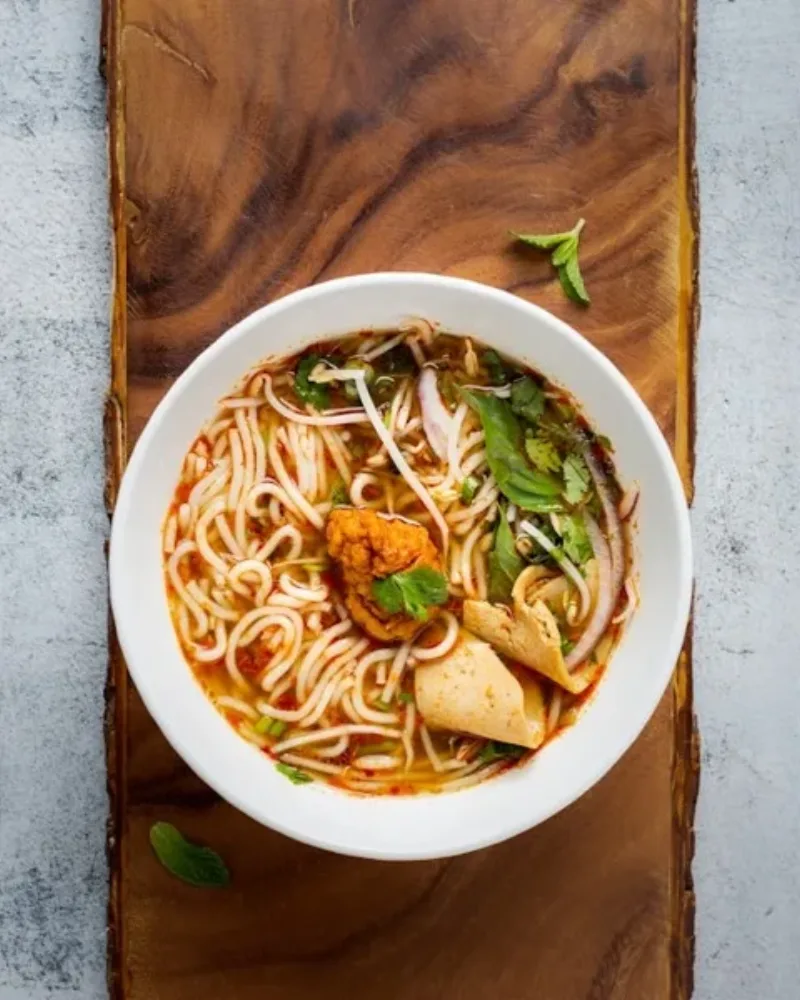 Cao lau noodles and white rose dumplings on a table